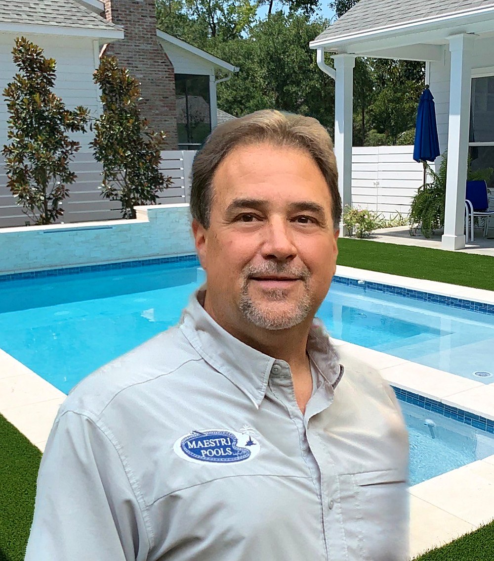 Gary Maestri, Sr. standing at a finished residential pool